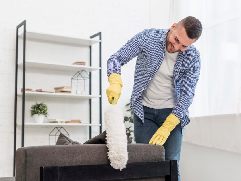 front-view-man-using-duster cleaning